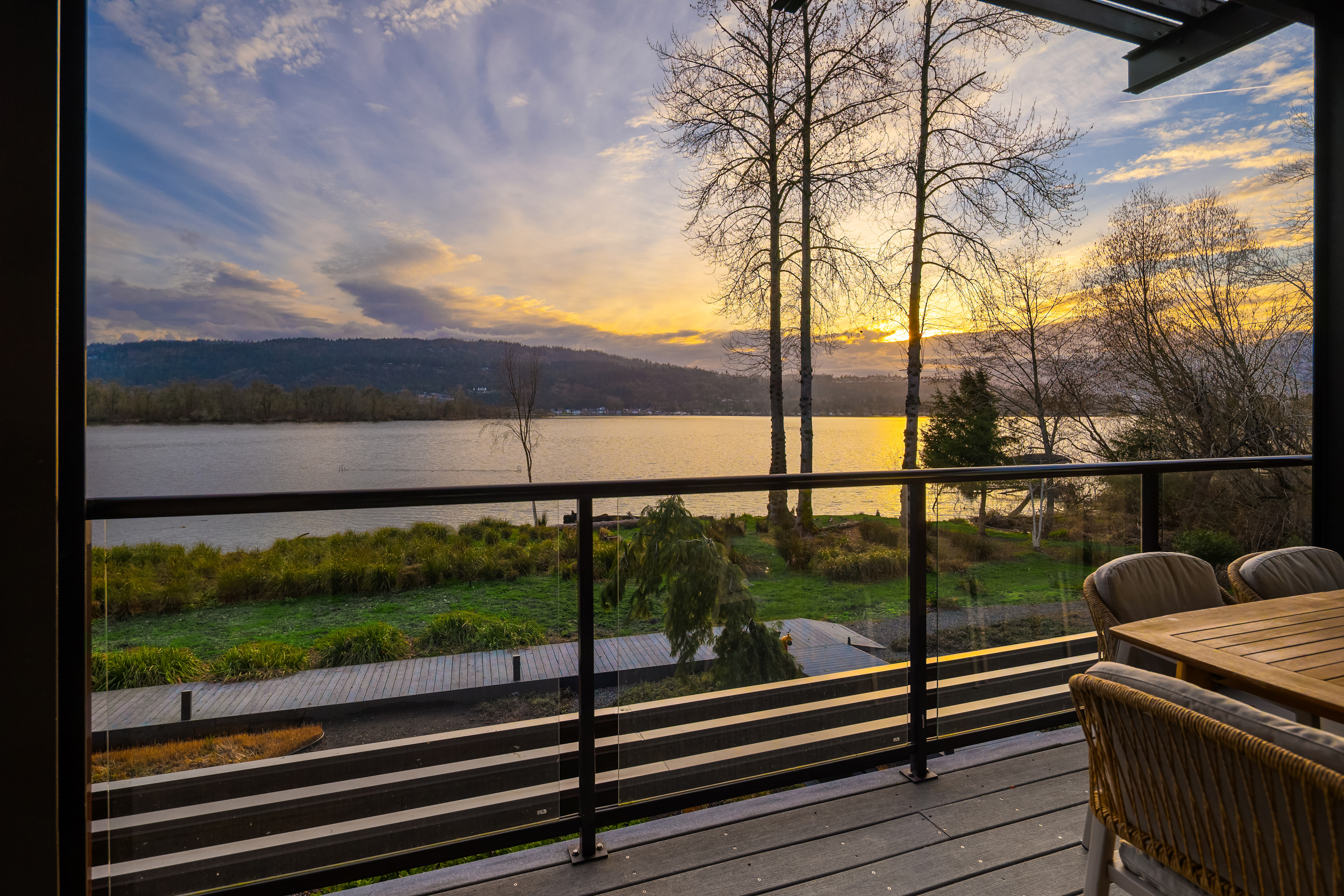 Deck with lake and mountain views at sunset