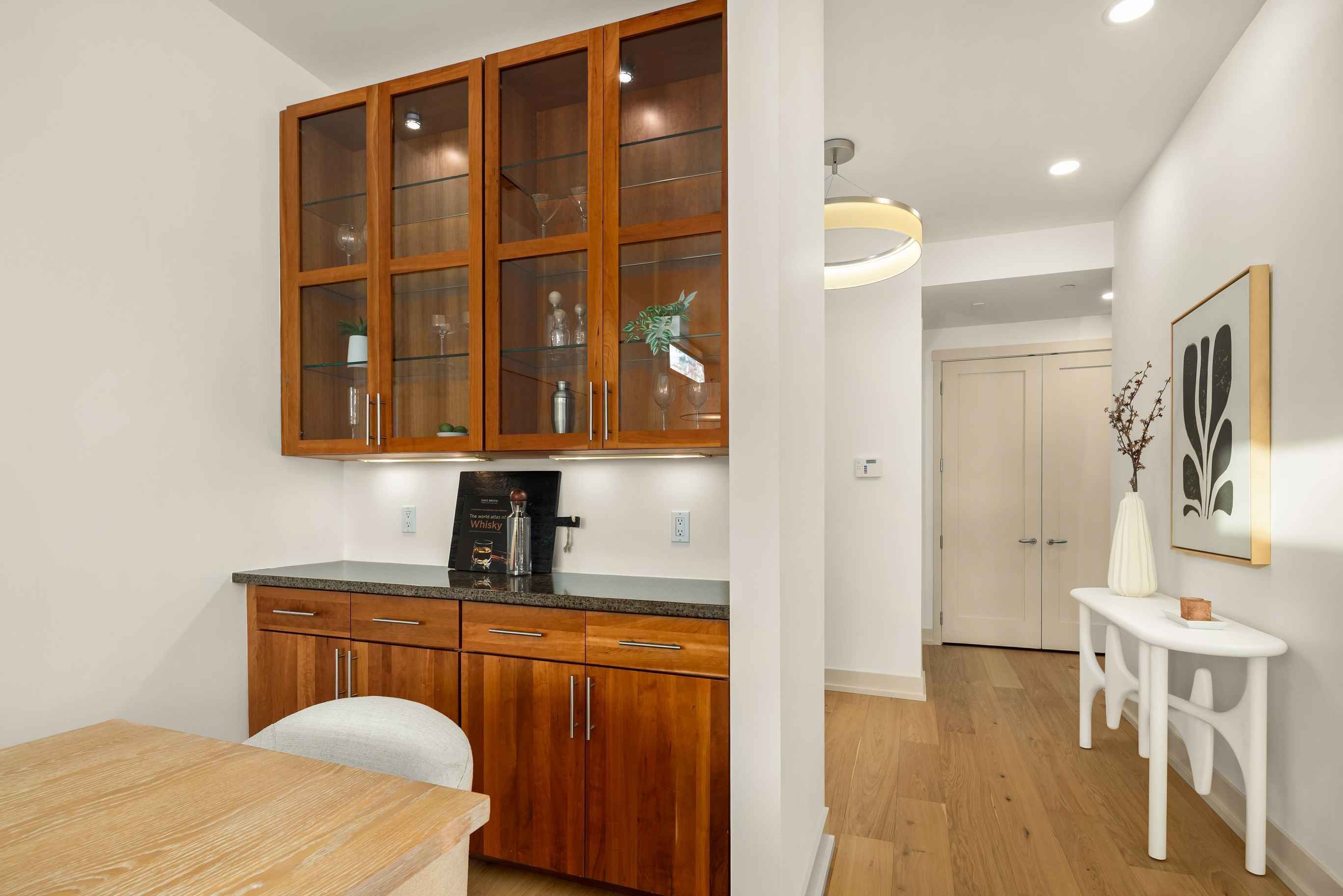 Wet bar with wood cabinetry